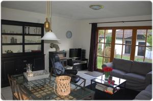 a living room with a couch and a table at Ferienhaus Kellerwald in Frankenau +18 photos