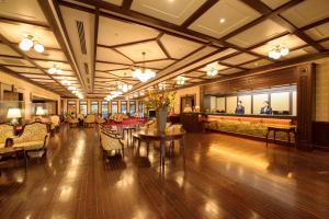 a lobby with couches and tables in a building at Kanazawa Hakuchoro Hotel Sanraku in Kanazawa