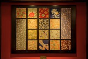 a framed picture of a window with oriental designs at Kanazawa Hakuchoro Hotel Sanraku -Natural Hot Spring- in Kanazawa