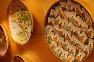 a plate hanging on a wall next to another plate at Kanazawa Hakuchoro Hotel Sanraku -Natural Hot Spring- in Kanazawa