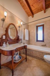 a bathroom with a sink and a mirror and a tub at Villa Russelia in Kalavárda