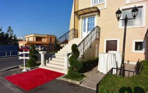a house with a red carpet in front of it at Hotel Arizona in Timişoara