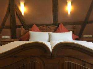 uma cama grande com um livro aberto em Fachwerk-Hotel Eisenbart em Hannoversch Münden