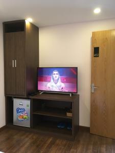 a flat screen tv sitting on a stand in a room at The Alley Hostel in Nha Trang +19 photos