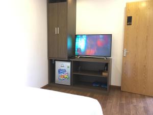 a room with a flat screen tv sitting on a entertainment center at The Alley Hostel in Nha Trang
