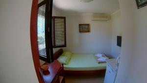 a small room with a bed and a window at Apartments Krivokapic in Kotor