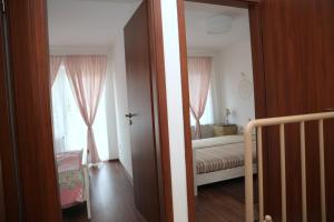 a room with a bedroom with a bed and a window at Rozmaring Pihenőház in Velence