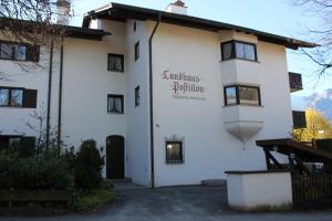 a white building with a sign on the side at Apartment Anastasia in Garmisch-Partenkirchen
