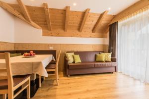 een eetkamer met een tafel en een bank bij Apt Bel Pre in La Villa