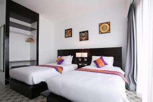 Postel nebo postele na pokoji v ubytování SakSukSmile Resort