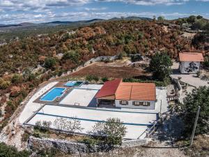 an aerial view of a house with a swimming pool at Holiday Home Poljičko Imanje in Donji Dolac