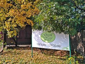 a sign for a greenfield garden center under a tree at Green Hostel Wrocław przy ZOO in Wrocław