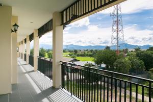 a balcony with a view of the mountains at SakSukSmile Resort in Sukhothai