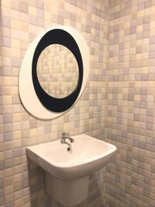 a bathroom with a sink and a mirror at Kiri Tawan in Ban Tai