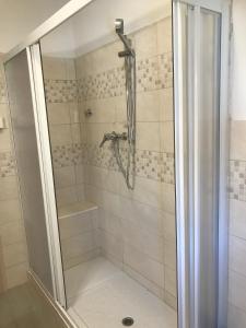a shower with a glass door in a bathroom at Albergo Chiara in Savignone