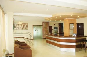 a lobby with chairs and a bar in a building at Omiros Hotel in Athens