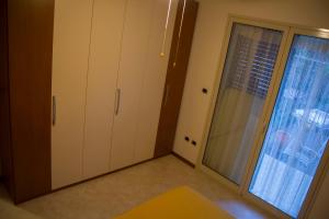 マスカリにあるPrato del Mareの白いキャビネットと大きな窓が備わる客室です。