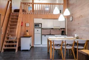 a kitchen with a table and chairs and a staircase at Vuokatti Weekend in Vuokatti