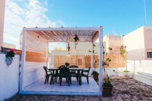 a table and chairs under a pergola on a patio at Dimora Storica Monopoli in Monopoli