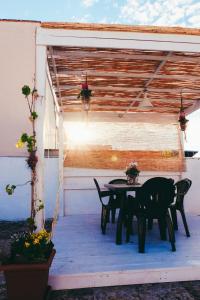 a patio with a table and chairs under a shed at Dimora Storica Monopoli in Monopoli