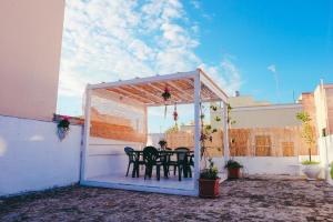 a gazebo with chairs and a table on a patio at Dimora Storica Monopoli in Monopoli