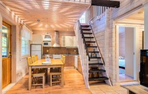a kitchen with a spiral staircase in a house at Vuokatti Weekend Lux in Vuokatti