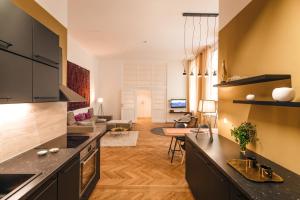 a kitchen with a counter and a living room at The Temple in Vienna