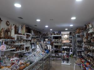 a store filled with lots of items on shelves at Residencial Coroa D'Ouro in Fátima