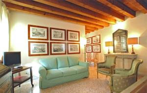 - un salon avec un canapé bleu et deux chaises dans l'établissement Casa Contarini, à Venise