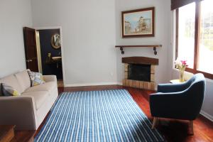 a living room with a couch and a fireplace at Casa Mirabonita in Lima