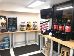 a coffee shop with a counter with drinks on it at At Home Inn - Fort Pierce in Fort Pierce