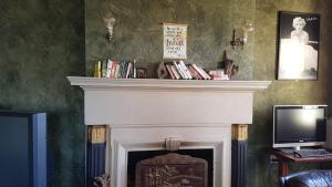 a living room with a fireplace and a television at Whakatane Hotel in Whakatane