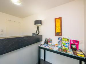 
a room with a table and a lamp at Bellano Motel Suites in Christchurch
