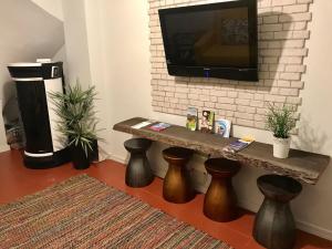 a living room with a table and a tv at Casa da Ponte Amarela in Aveiro