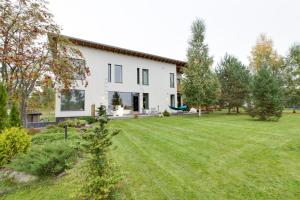 a house with a large lawn in front of it at Sun Villa in Imatra
