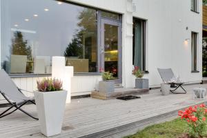 a deck with chairs and flowers on a house at Sun Villa in Imatra