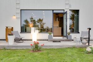 a house with a patio with chairs and a window at Sun Villa in Imatra