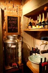 a kitchen with a counter with a pot and wine bottles at La Bussola Da Gino in Quarrata