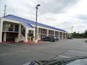 un grande edificio con un'auto parcheggiata in un parcheggio di Motel 6-Memphis, TN - East a Memphis