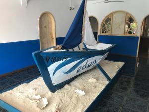a small boat sitting on a table in a room at Eden Villa in Belle Mare