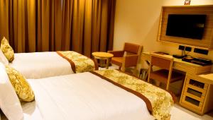 Mango Hotels Vijayawada客房内的一张或多张床位