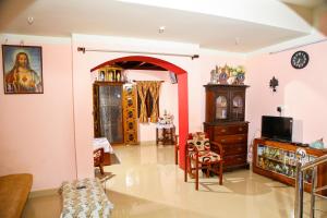 a living room filled with furniture and a tv at Mom&Pop Thyparambil Heritage in Alleppey