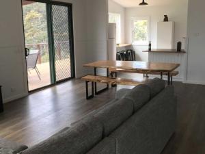 a living room with a couch and a wooden table at Derby Digs Cottage in Derby