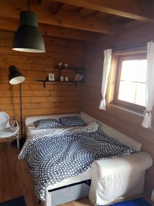 a bedroom with a bed in a room with a window at Drevenica Desina in Terchová