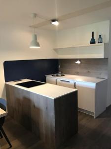 a kitchen with a counter top in a room at See-Apartment Weiden in Weiden am See
