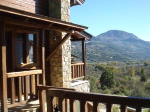 a balcony of a house with a view of a mountain at Efharis Filoxenon in Feneos