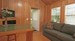 a living room with a couch and a table at Robin Hill Camping Resort Premium Cottage 1 in Lenhartsville