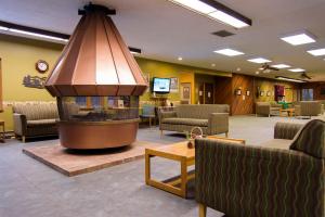 a lobby with a fireplace in a waiting room at Leavenworth Camping Resort Tiny House Adeline in Leavenworth