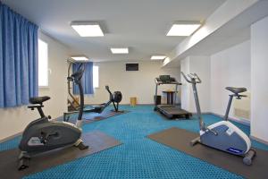 a gym with several exercise bikes and tread machines at Aka Lodge Lyon Est in Meyzieu