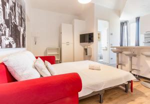 ミラノにあるAlessia's Flat - Sarpi 3のリビングルーム(赤いソファ、テレビ付)